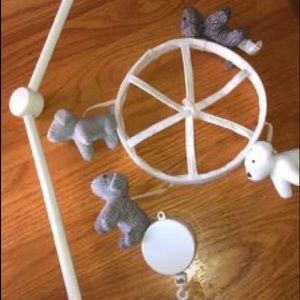 Pottery Barn dog mobile with a wooden arm.